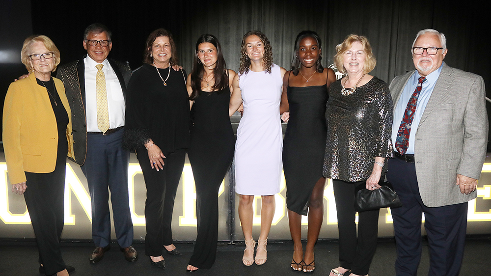 UNCP students pose with Chancellor Cummings and other UNCP leaders at Cash Bash 2025.