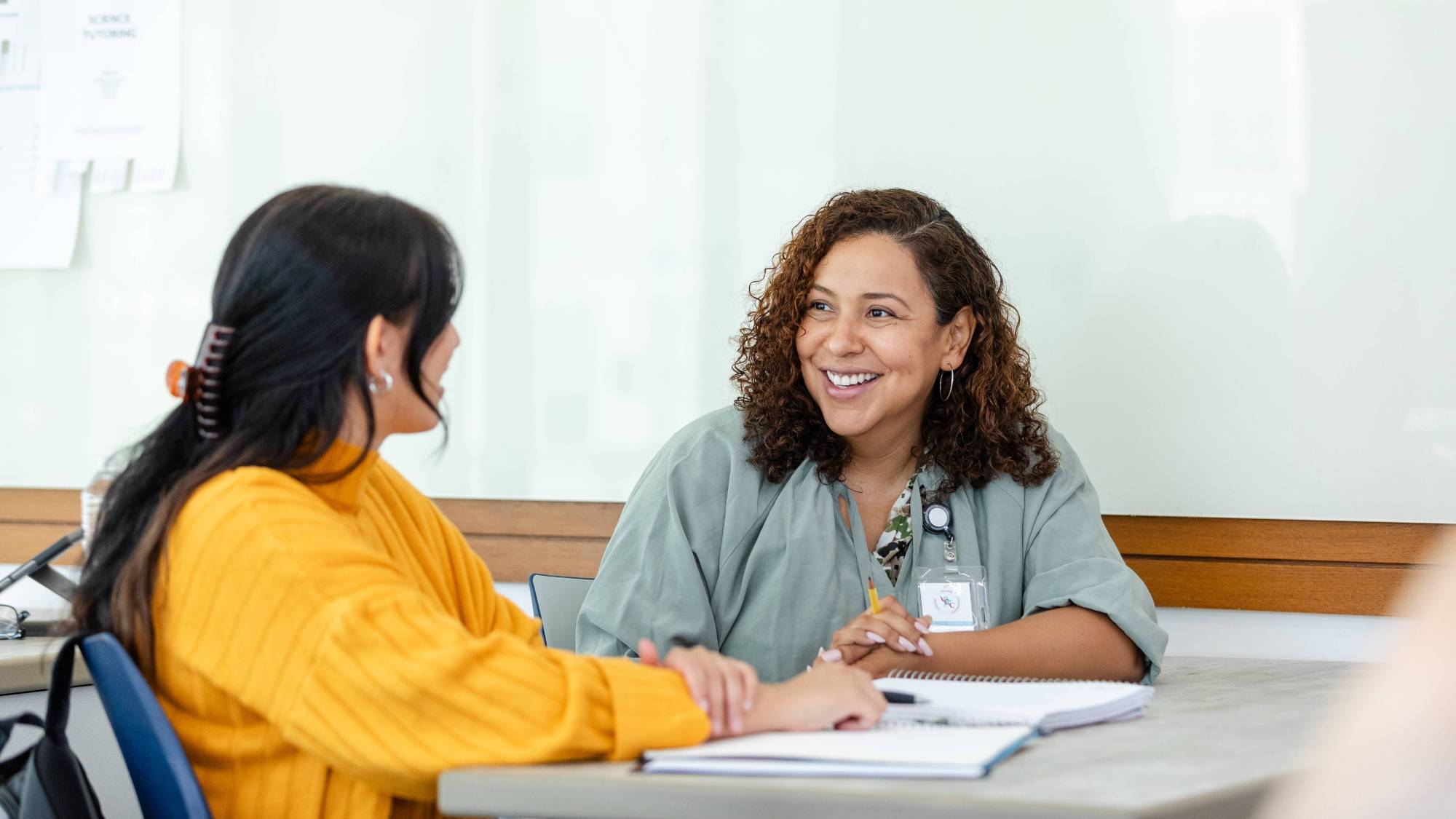 A teacher working with a high school student