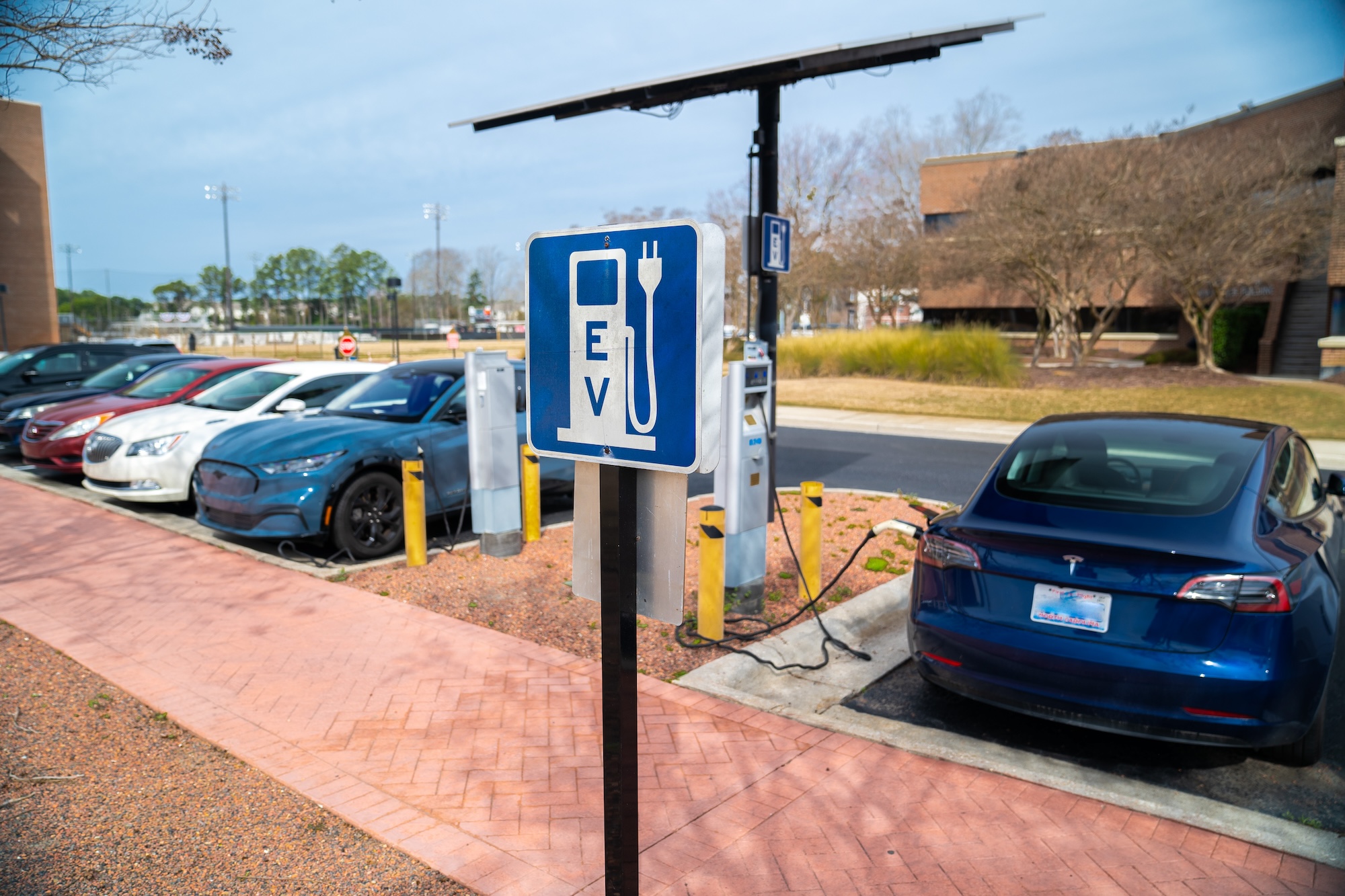 An electric vehicle charges at a UNCP campus EV charging station.
