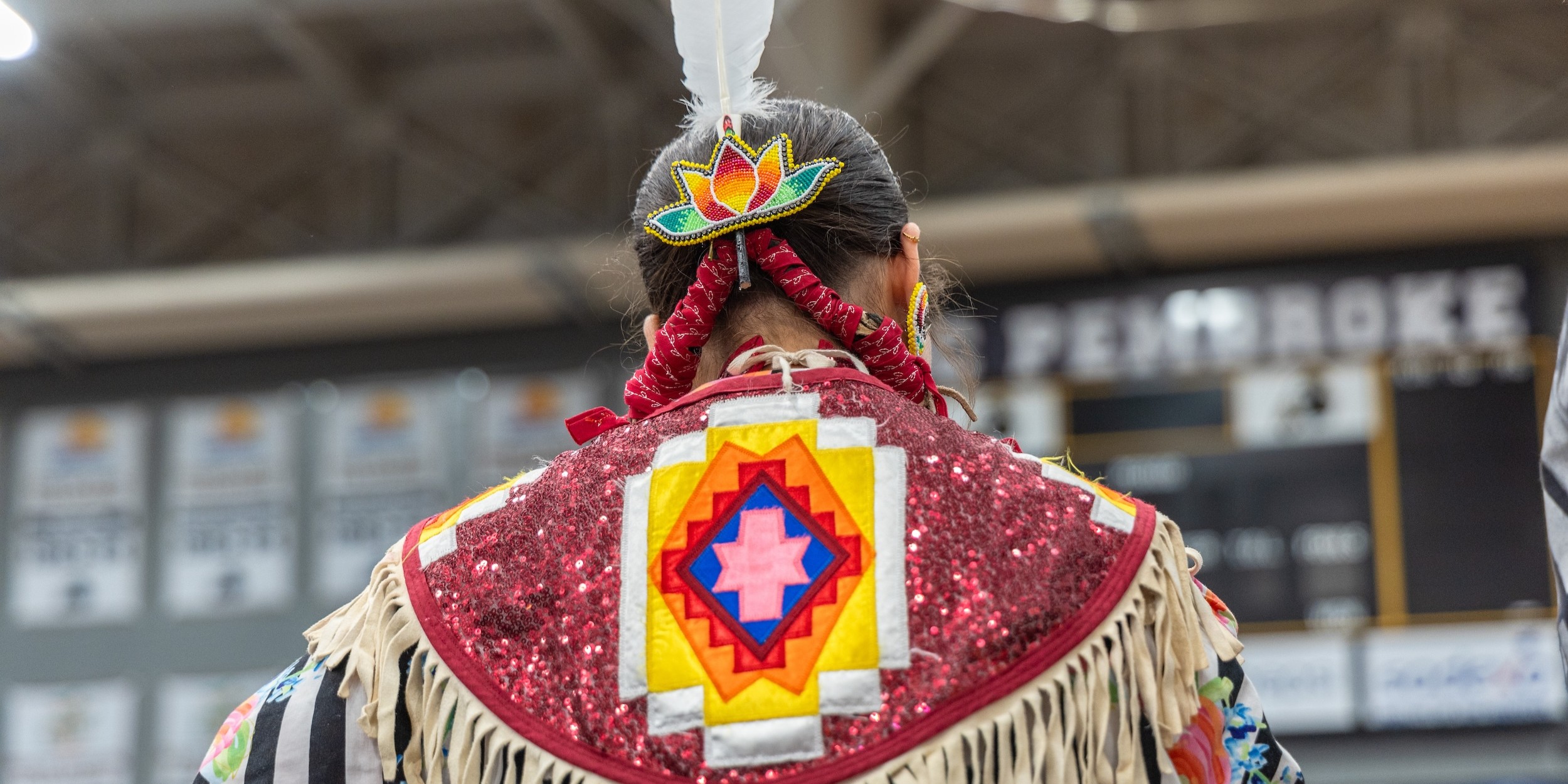 Back of a woman's American Indian regalia at BraveNation Powwow and Gathering at UNC Pembroke