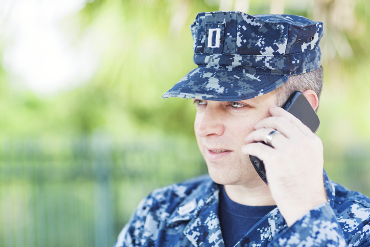 United States Naval Lieutenant talking on smart phone.