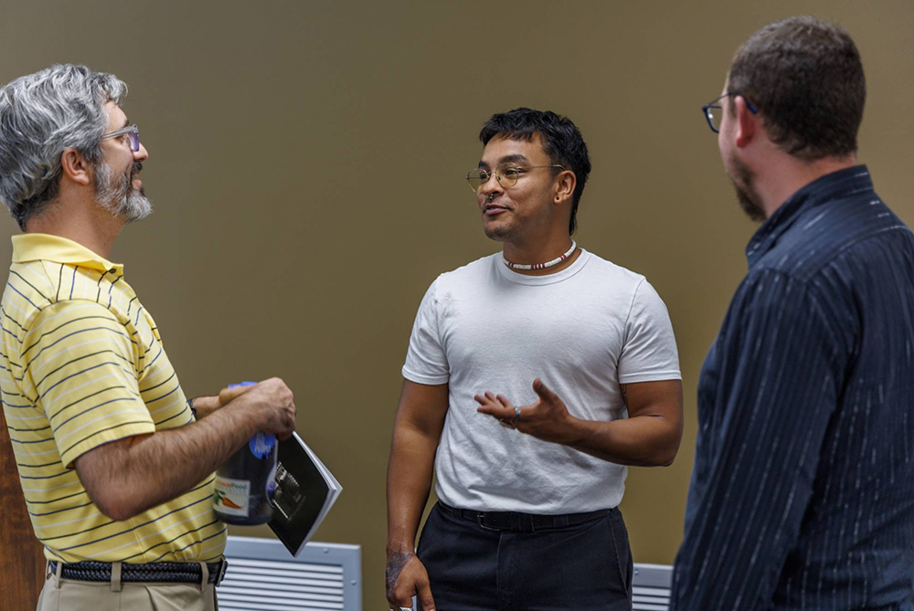A UNCP student at a live reading of their poem that was published in the Aurochs