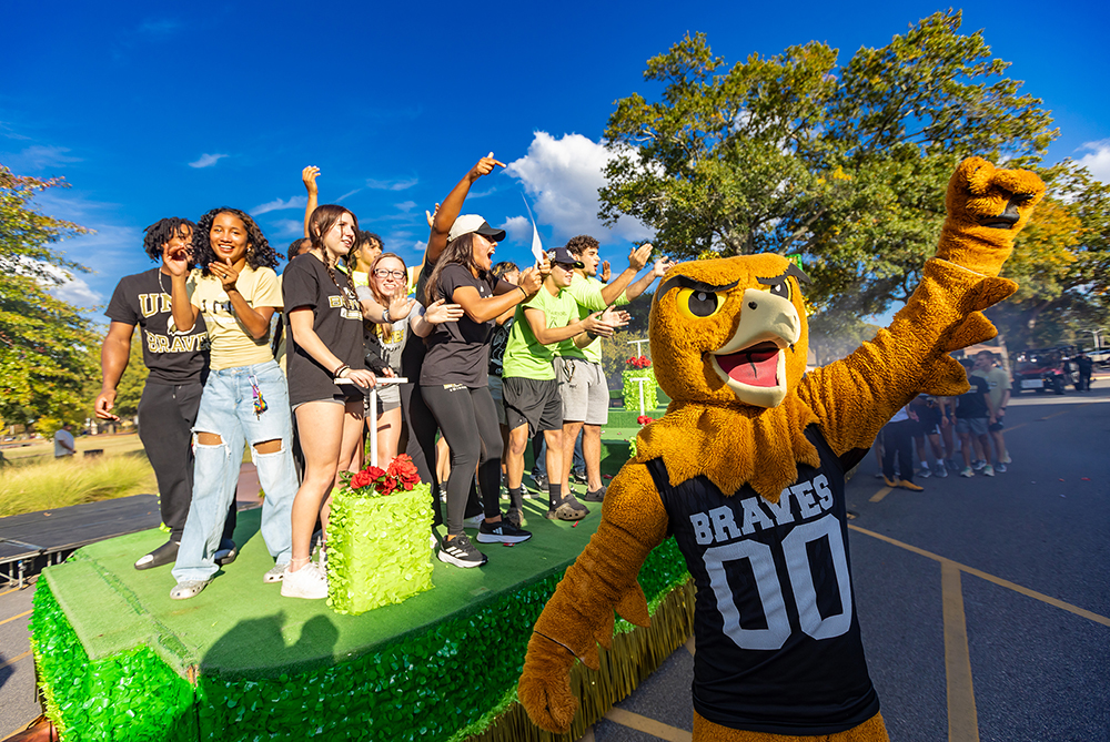 bravehawk and students on a homecoming float