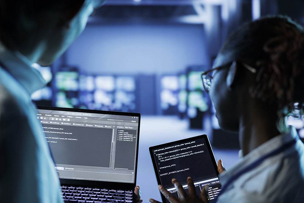 man at blue computer screen reviewing cyber data