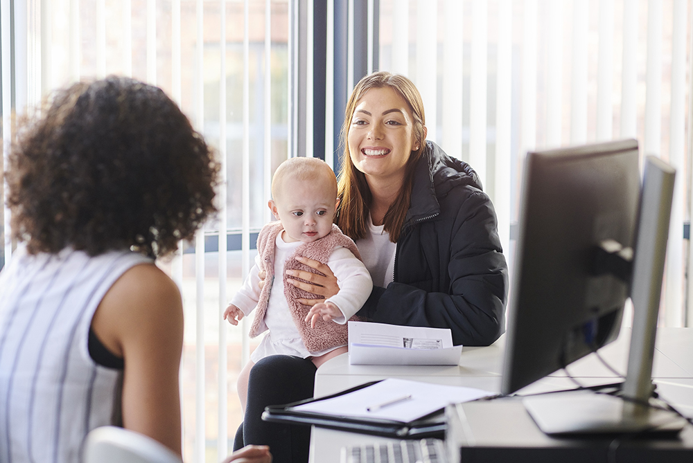 young woman with baby in office