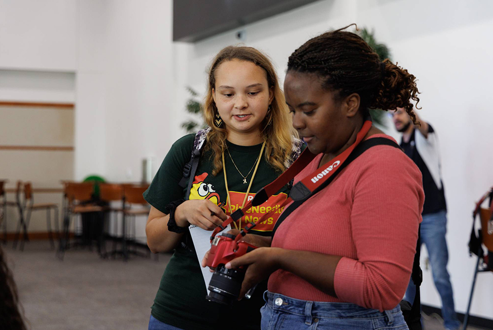 A photographer and reporter from the UNCP student newspaper, The Pine Needle