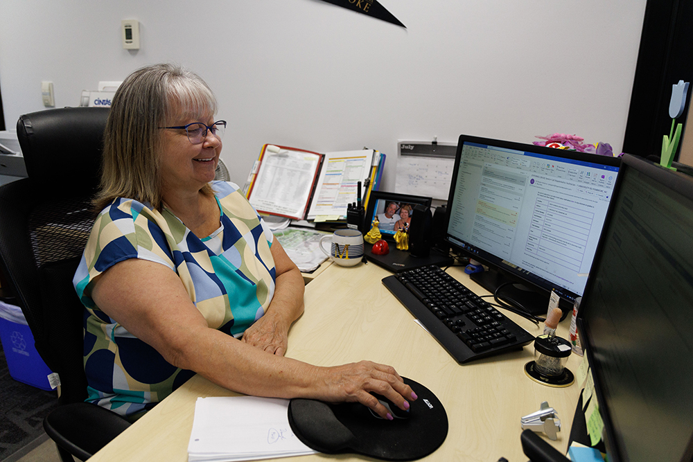 UNCP employee working on a computer