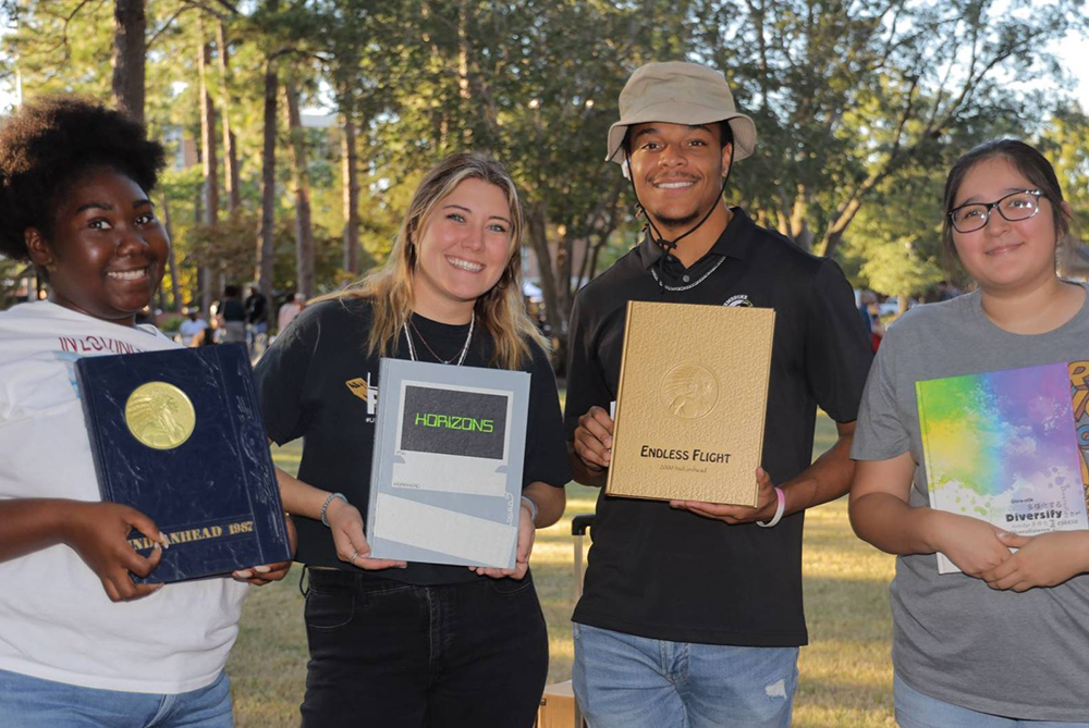 UNCP students on campus with older yearbooks