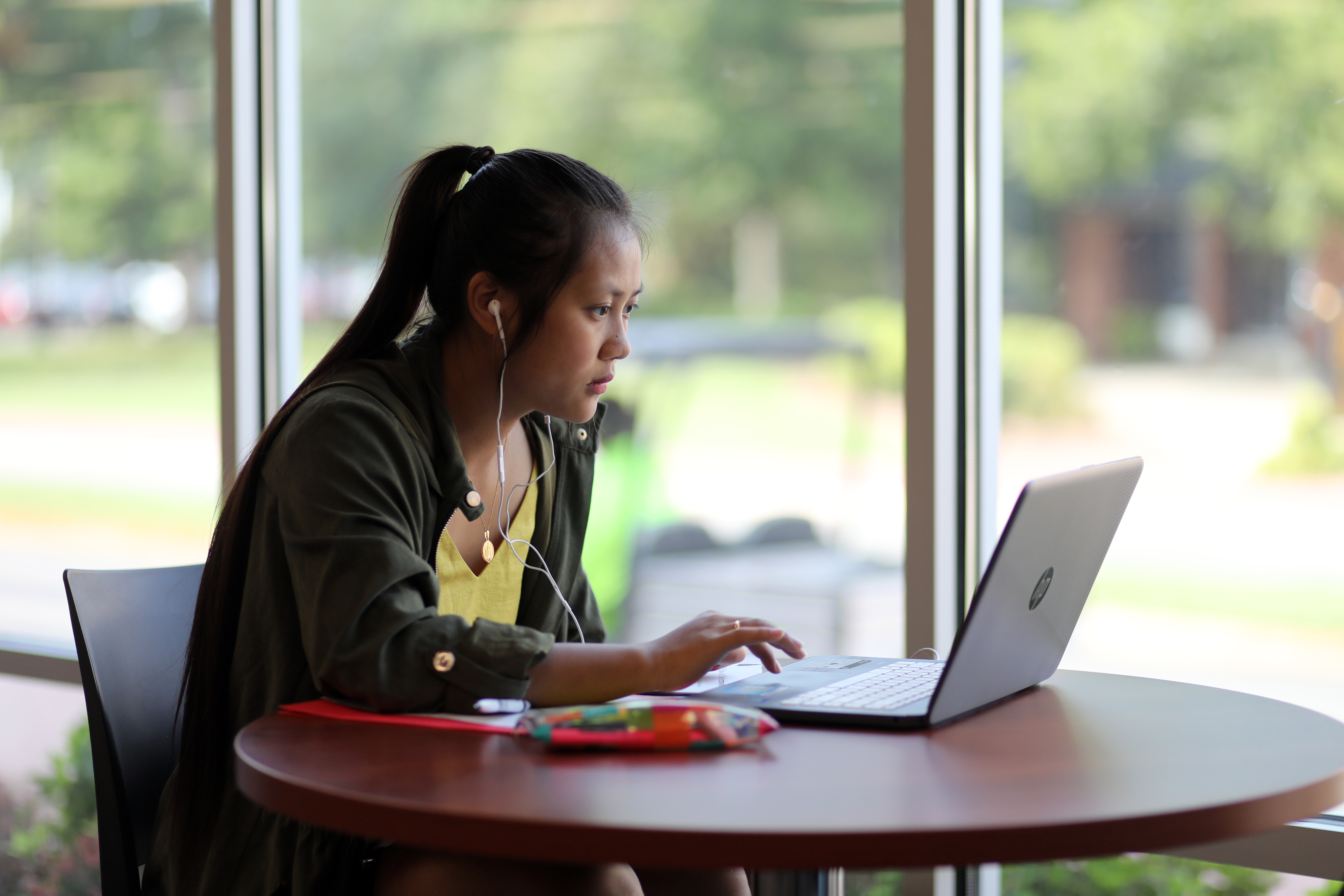 UNCP student sitting on a computer