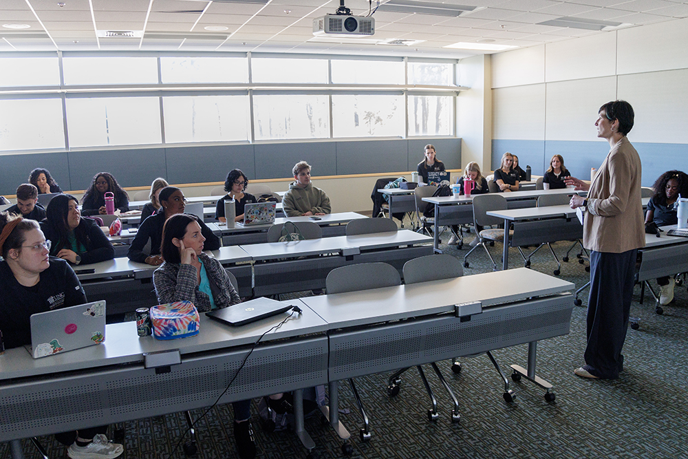 students listening to a member of the UNCP Occupational Therapy program