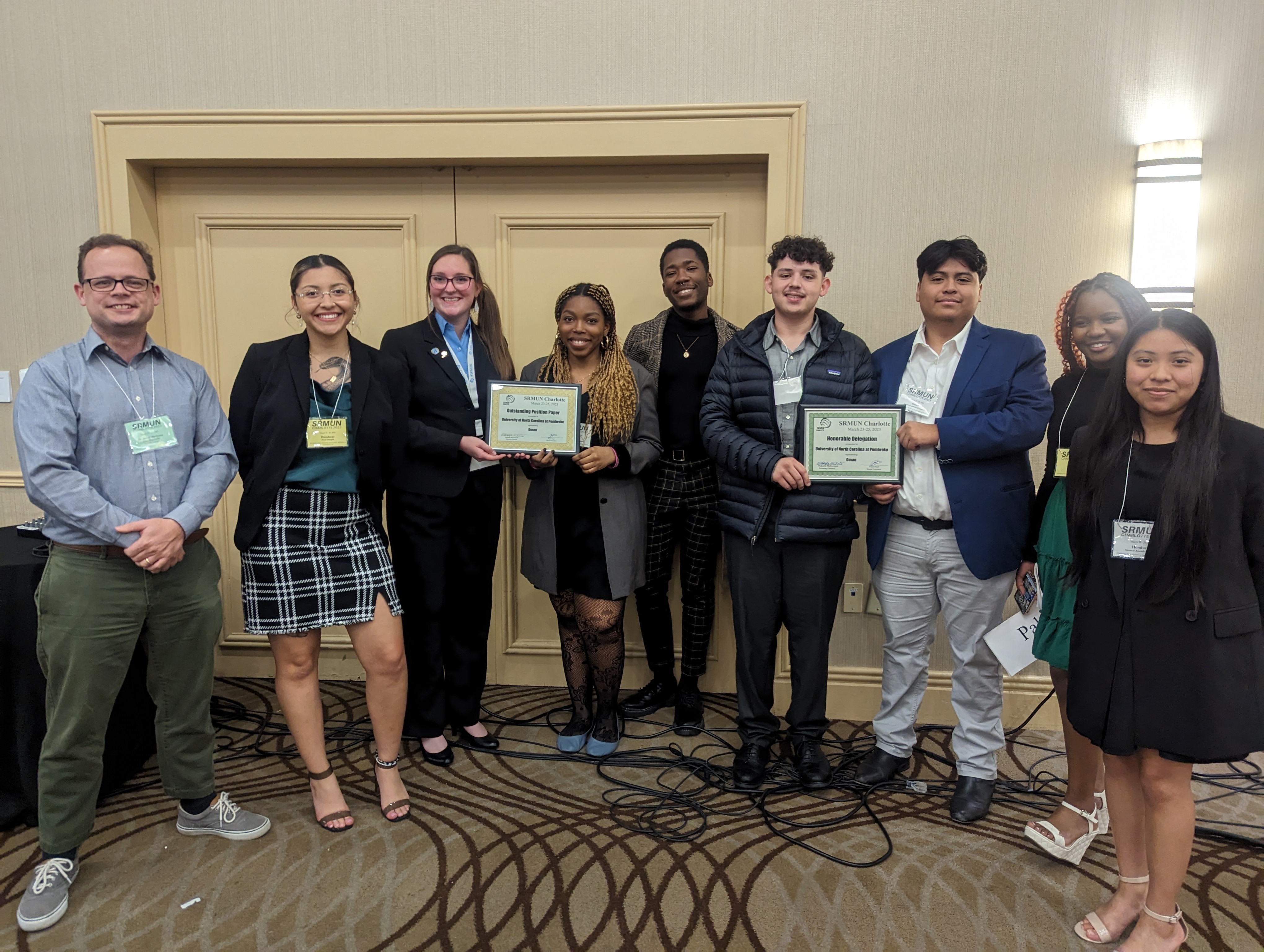 Dr. Josiah Marineau (far left), faculty advisor, is pictured with SRMUN team members Katie Aguilar Manueles, Aspen Andersson, Sharon Daminabo, Kristian Johnson , Ethan Deese, Jose Perez, Anesu Mavhiya, Magally Ortiz-Rojas
