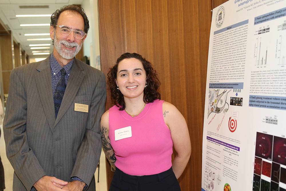 SLAM DUNC Alzheimers Symposium Ben Bahr and student with research poster