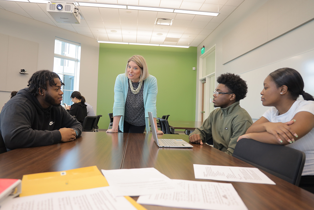 faculty and business students in class