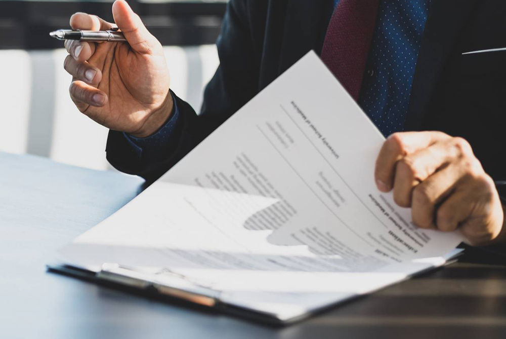 Documents on a clipboard with hands