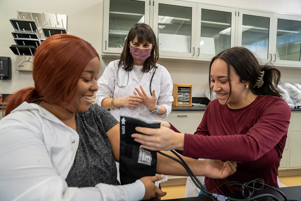 biology blood pressure lab teacher and students smiling