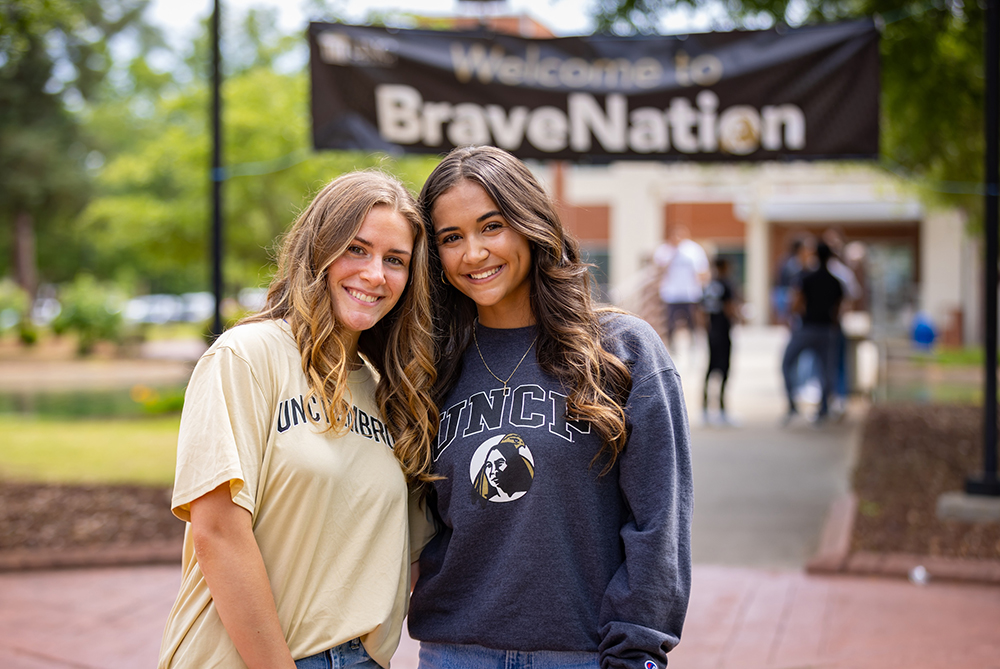 two female students smiling at the camera