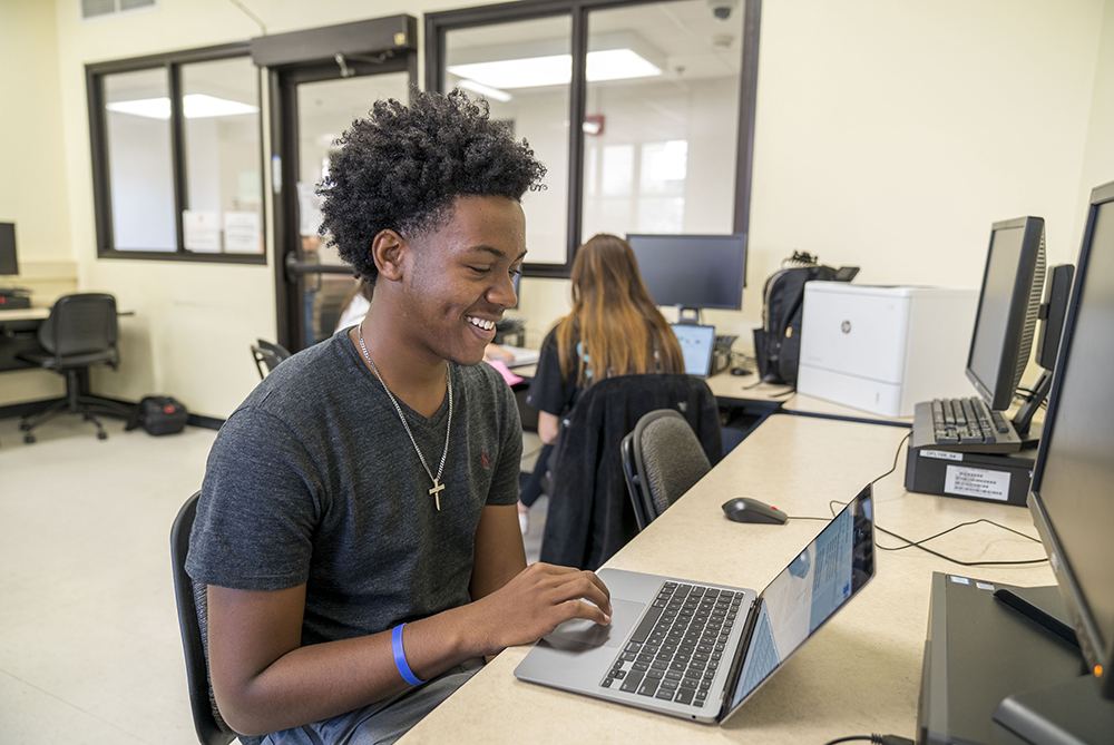male student on laptop UNCP