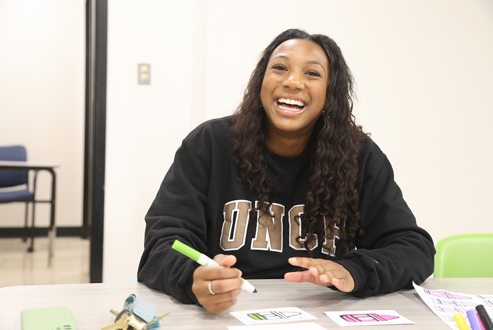 UNC Pembroke student creating flash cards for and elementary school.