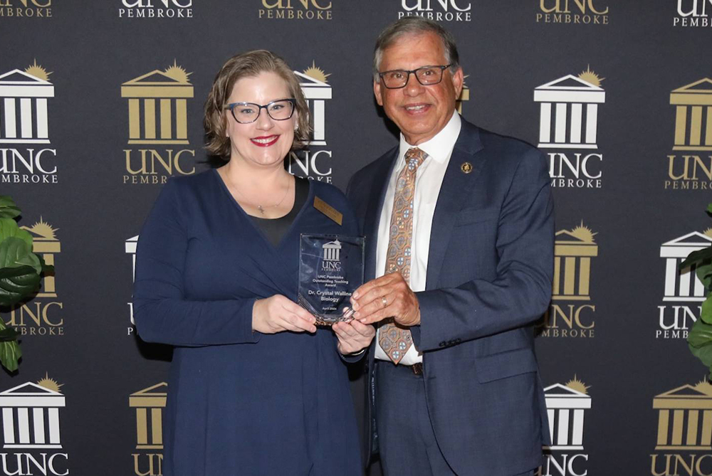 Crystal Walline and chancellor giving award