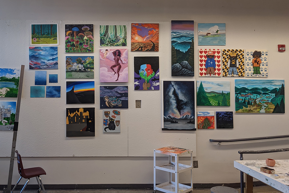 Student paintings on the wall of the painting studio in Locklear Hall at UNC Pembroke.