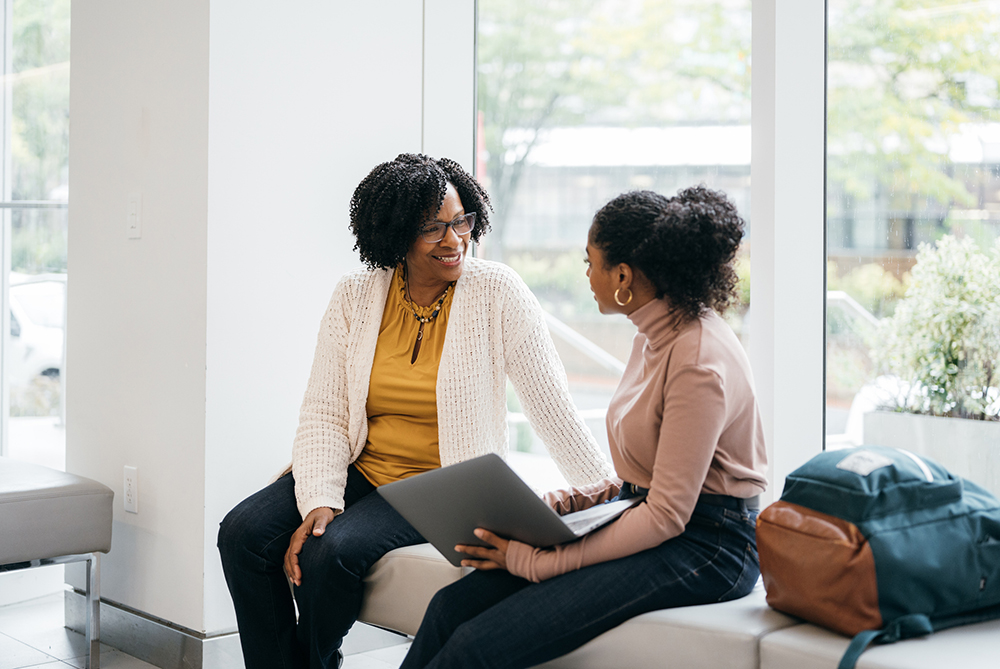 two women sitting and talking