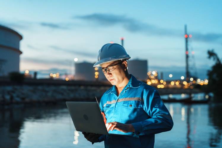 GIS technician looking at a computer on a job site