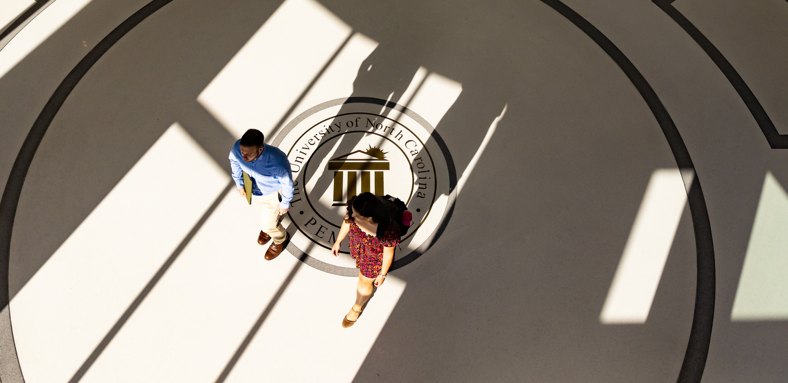 Business student walking in James A. Thomas Hall