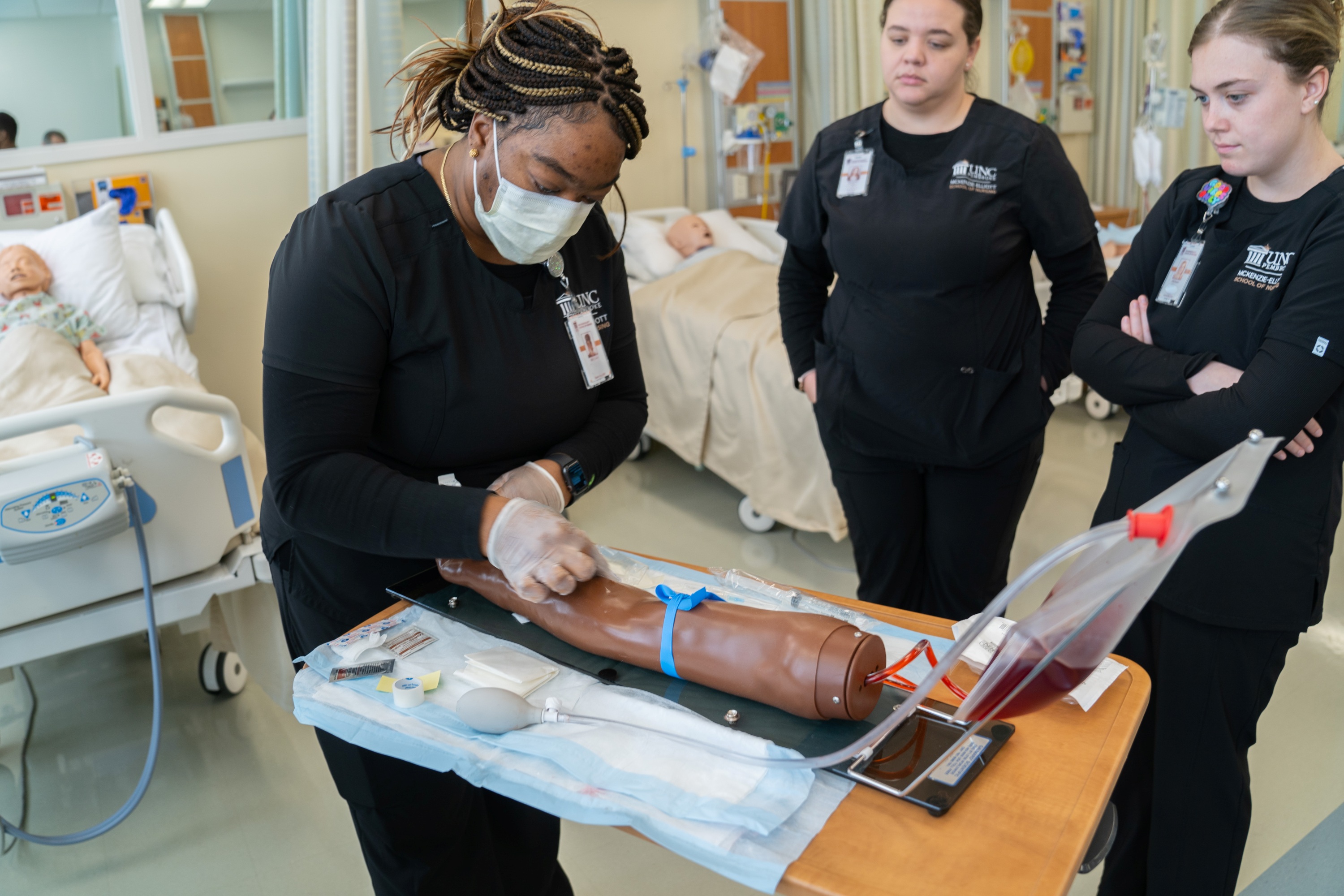 Nursing students practicing during an IV therapy simulation lab at UNC Pembroke.