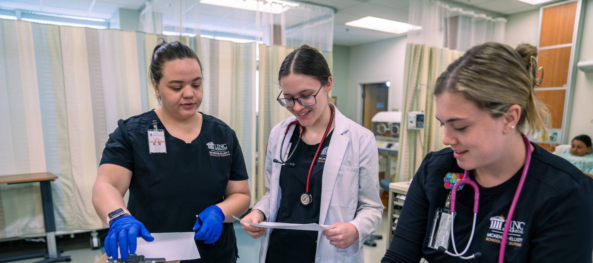 UNCP Nursing students confer in an ER setting