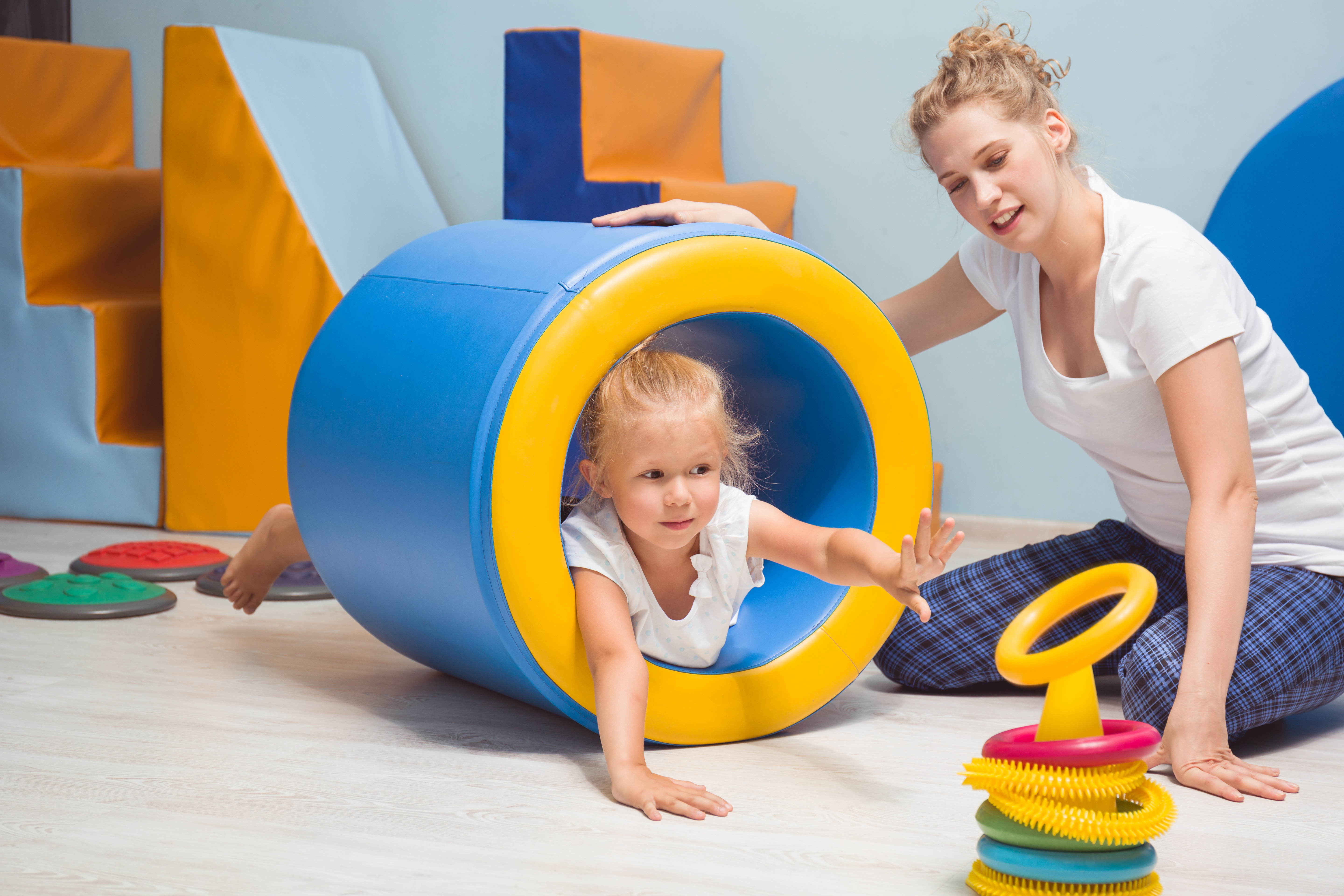 A woman and child in a play therapy session