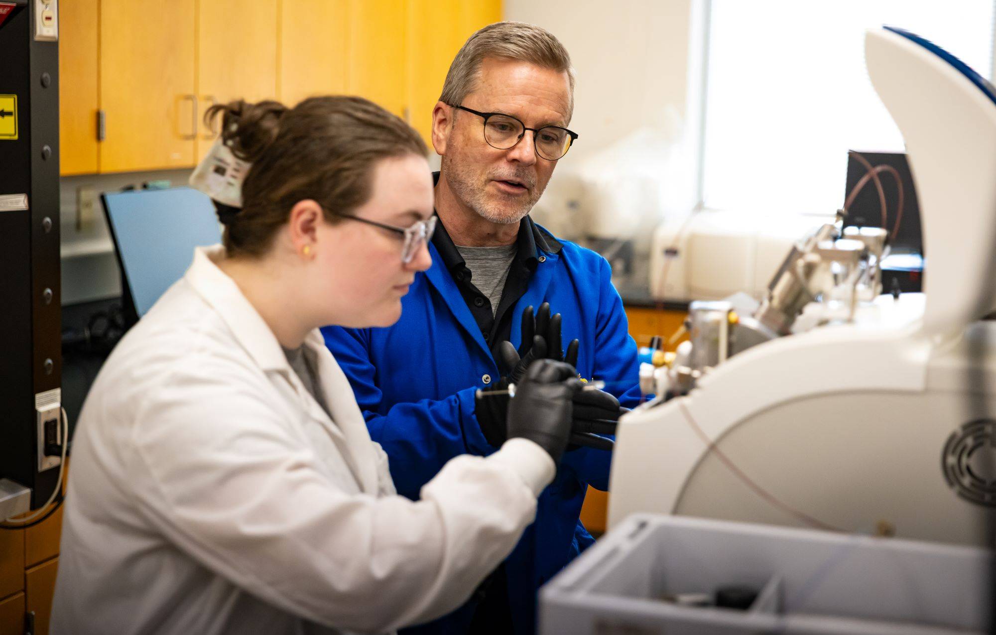 UNCP teacher working with student in a science class
