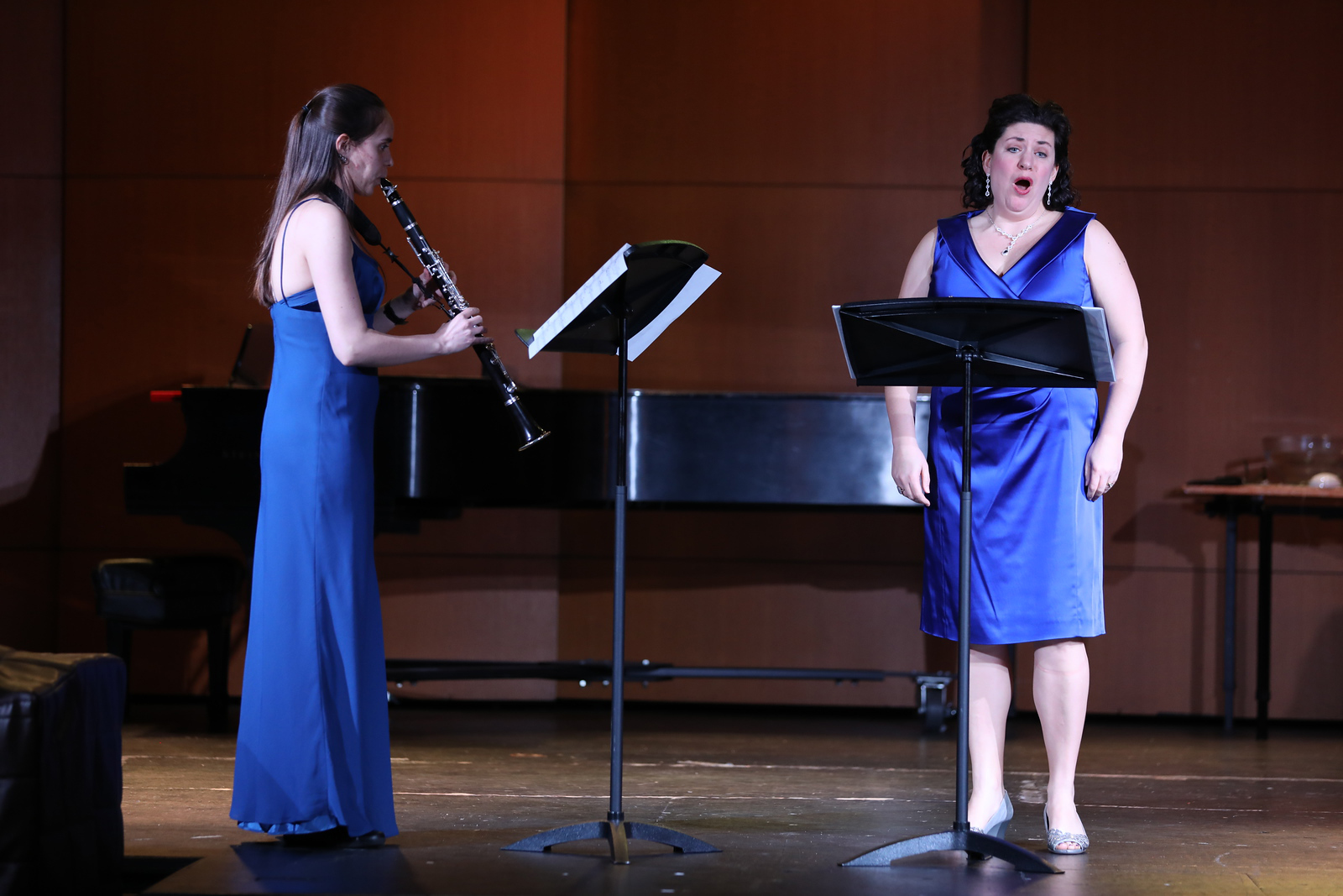 A UNCP music sings on stage, accompanied by a fellow student on clarinett