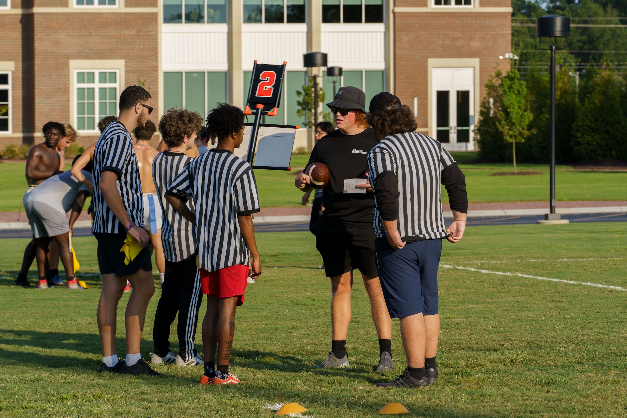 A group of coaches outside on the UNCP recreation field