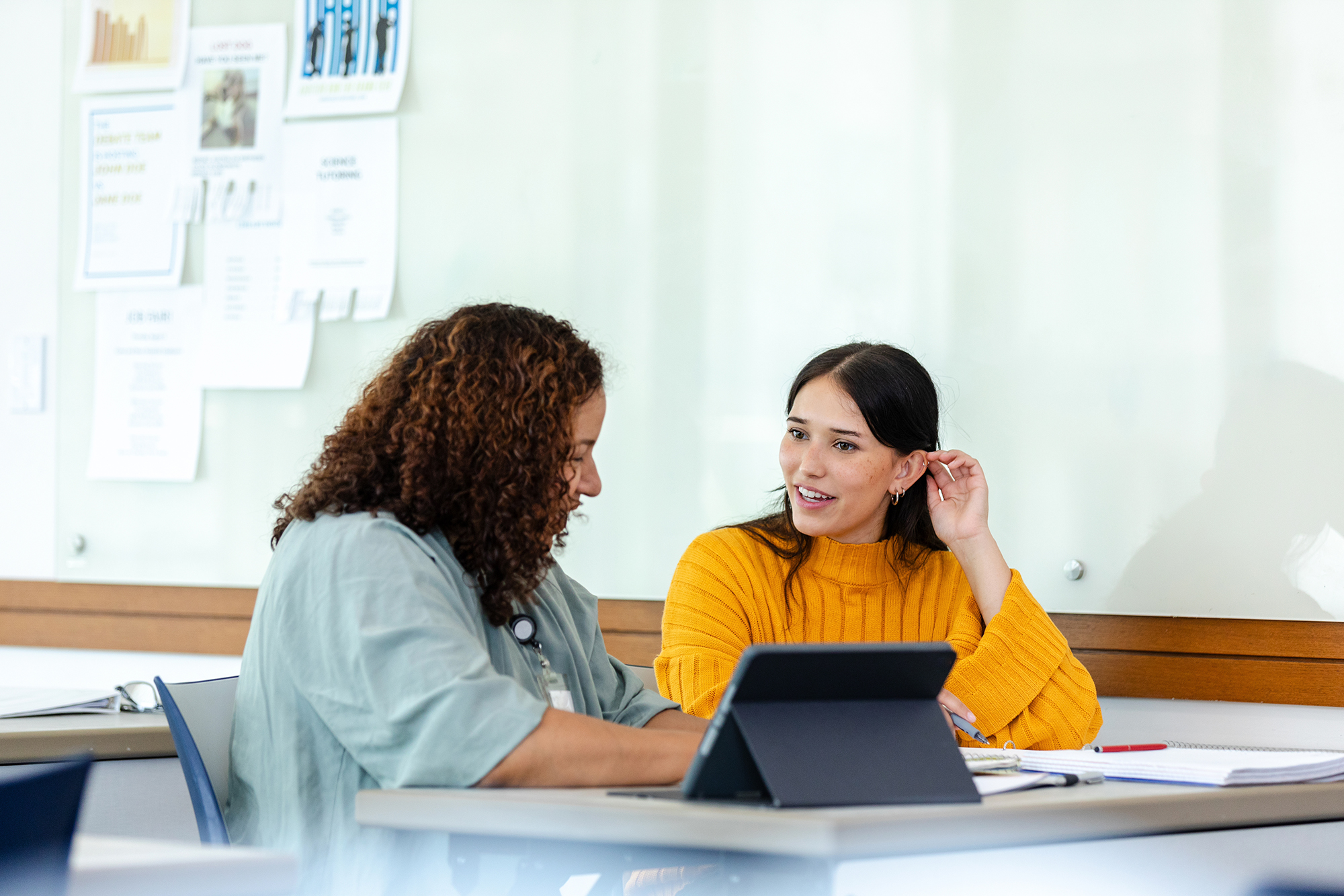 woman in yellow sweater talking with a counselor