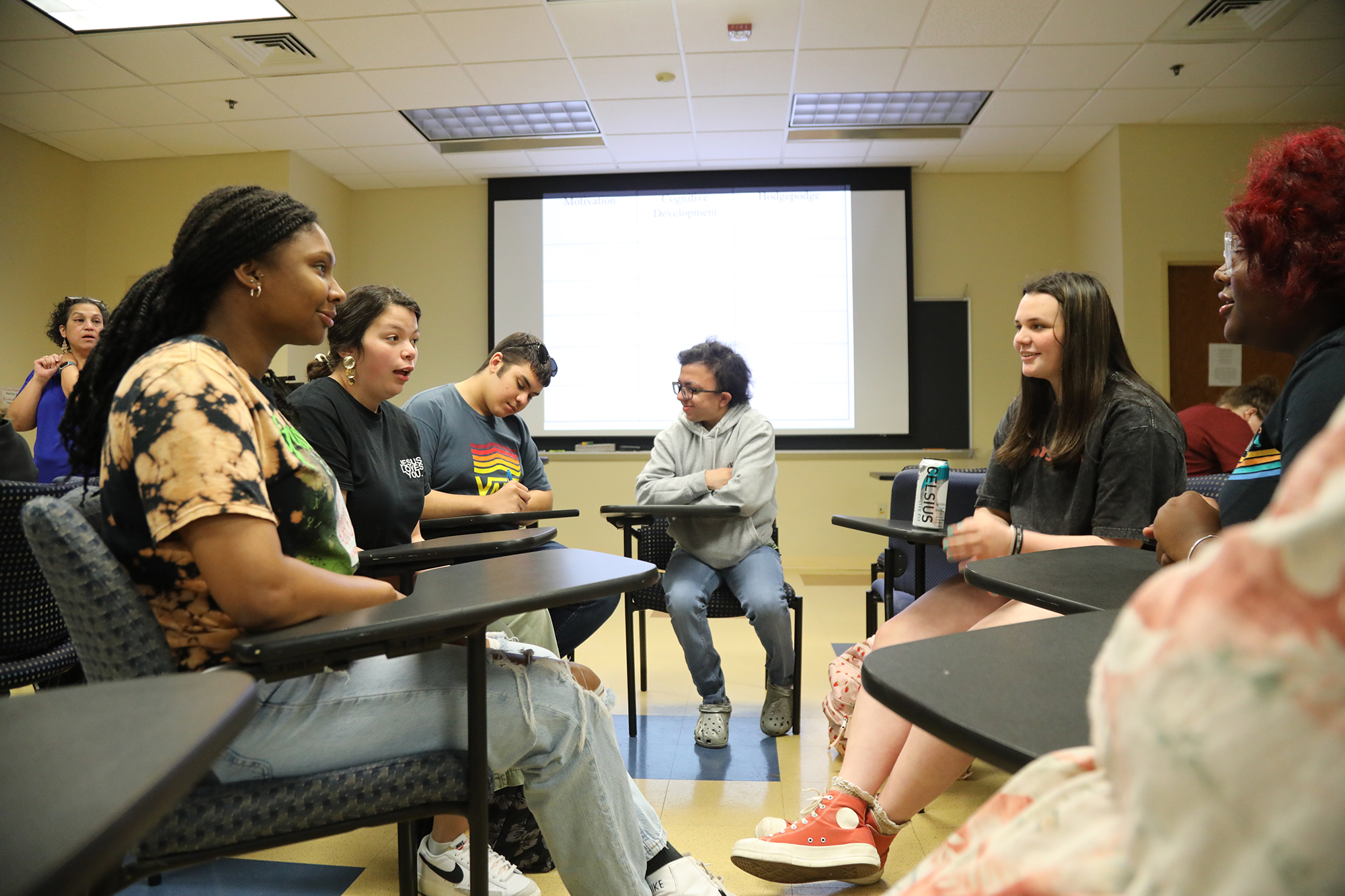 students talking in a group in a UNCP classroom