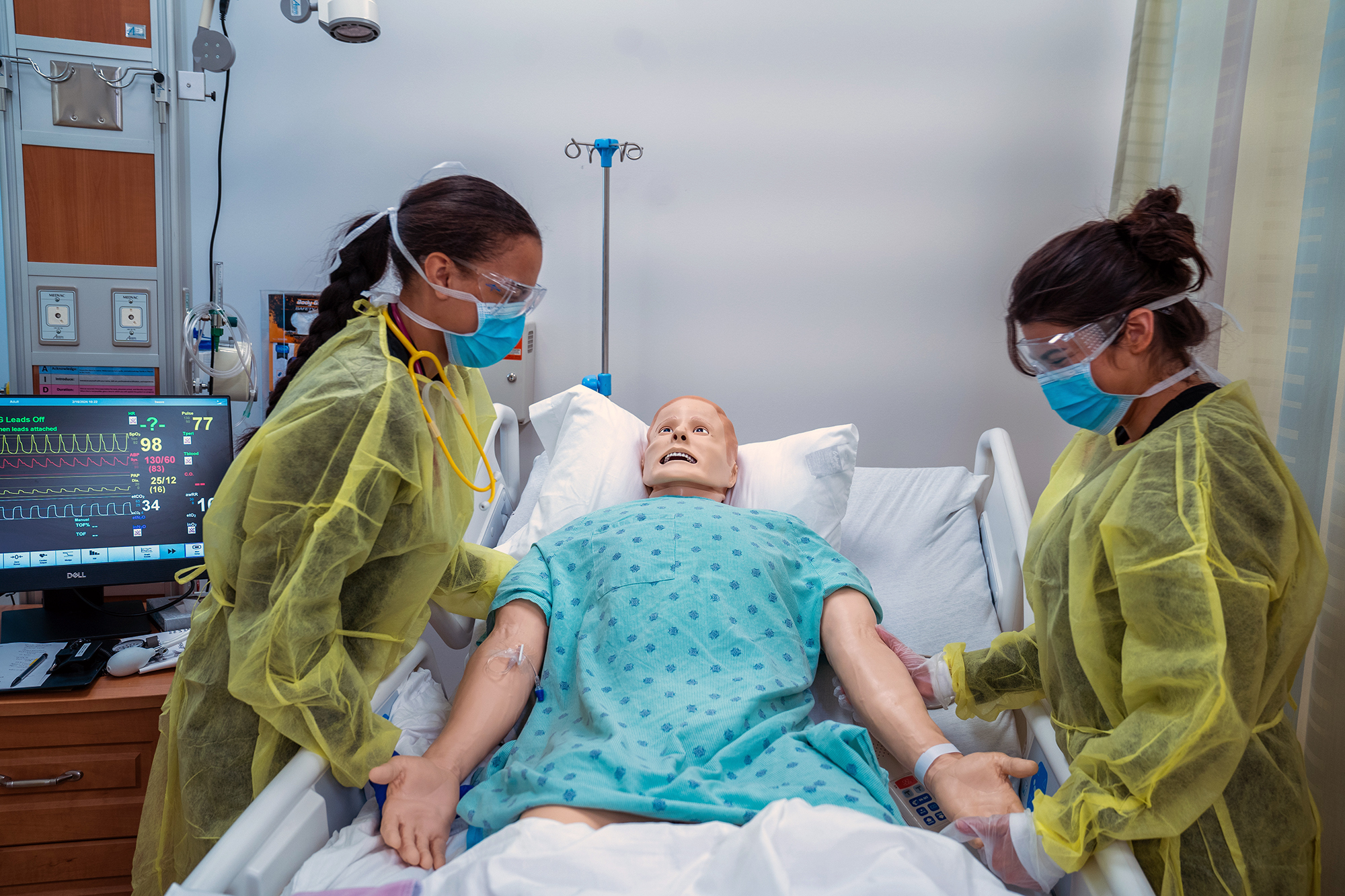 students in scrubs in a hospital like setting 