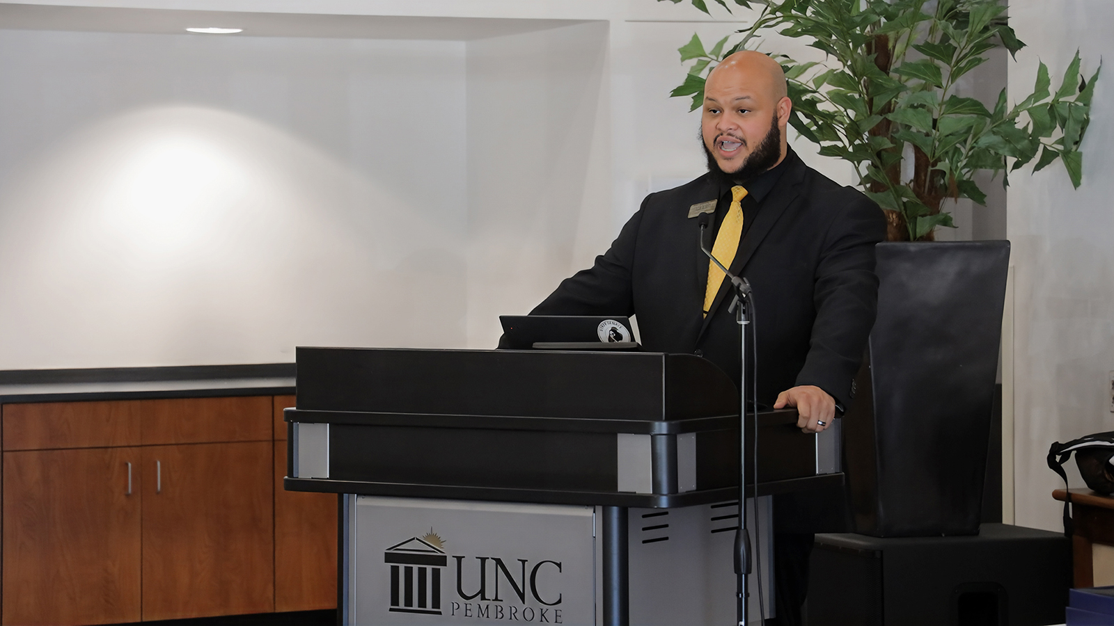 UNCP Staff Senate Chair Tim Sampson speaks at a luncheon