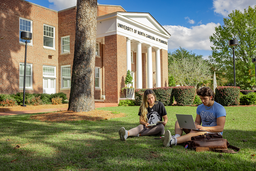 Students working by Old Main