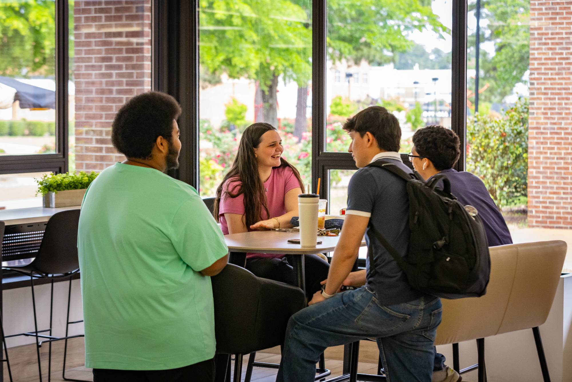 Group of UNCP students at table laughing