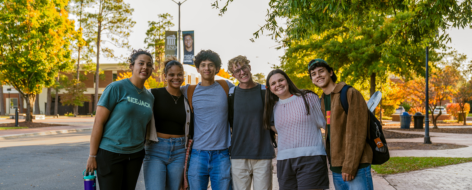 A group of students pose on the UNCP campus.