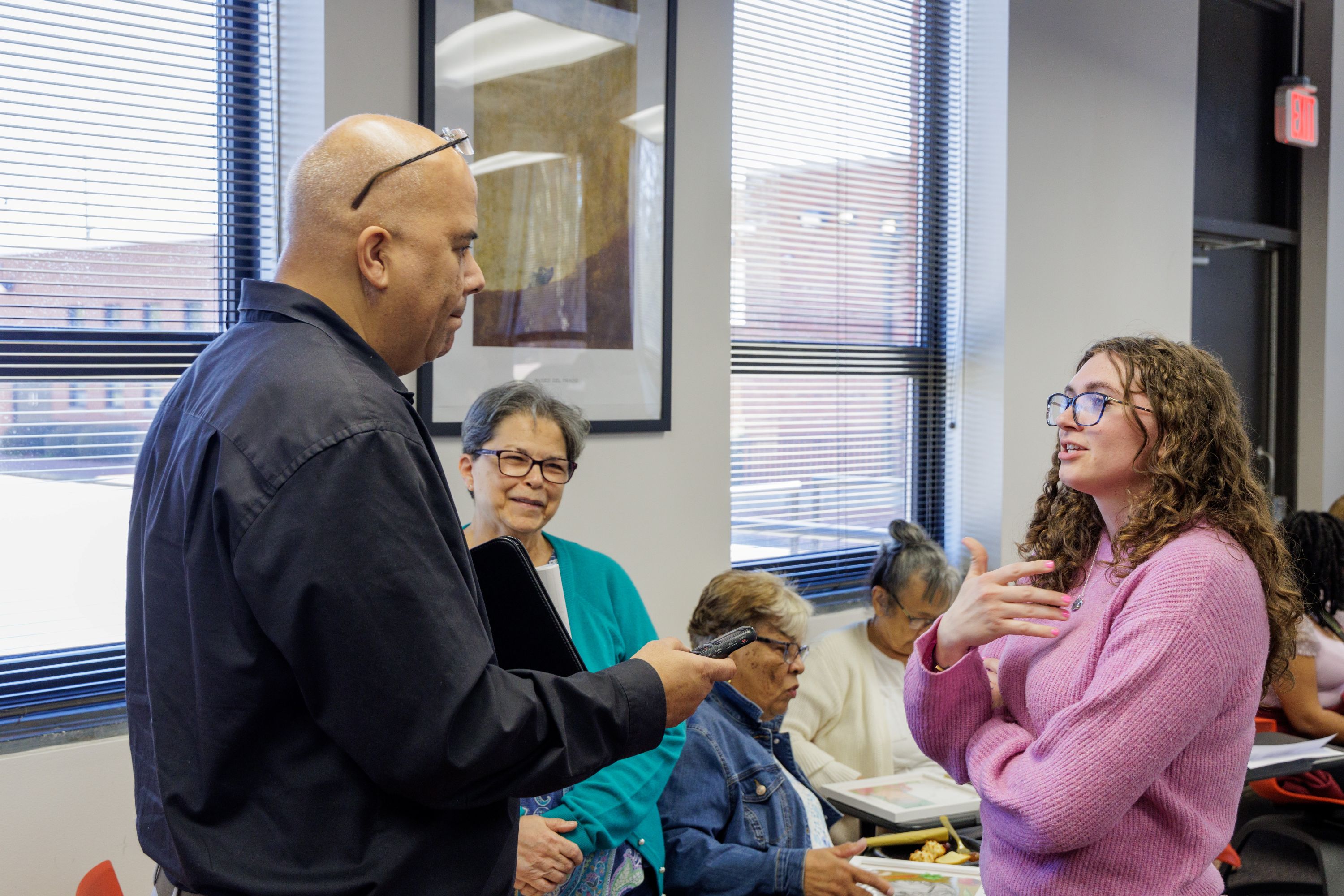 Mark Locklear, left, interviews a UNCP student, right, about her participation in a community portrait project.