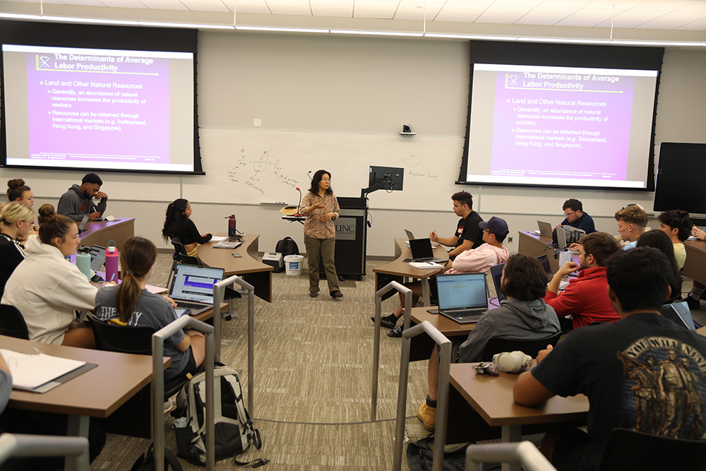 Business faculty member lecutures at the front of a classroom on UNC Pembroke's campus