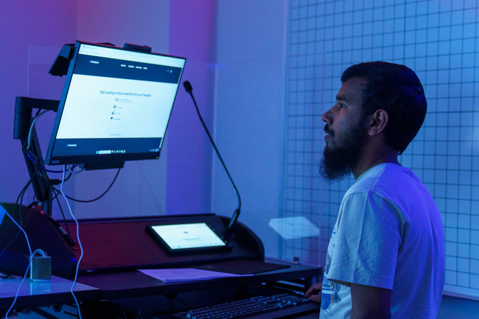 male student in Cybersecurity classroom at UNCP looks at computer monitor
