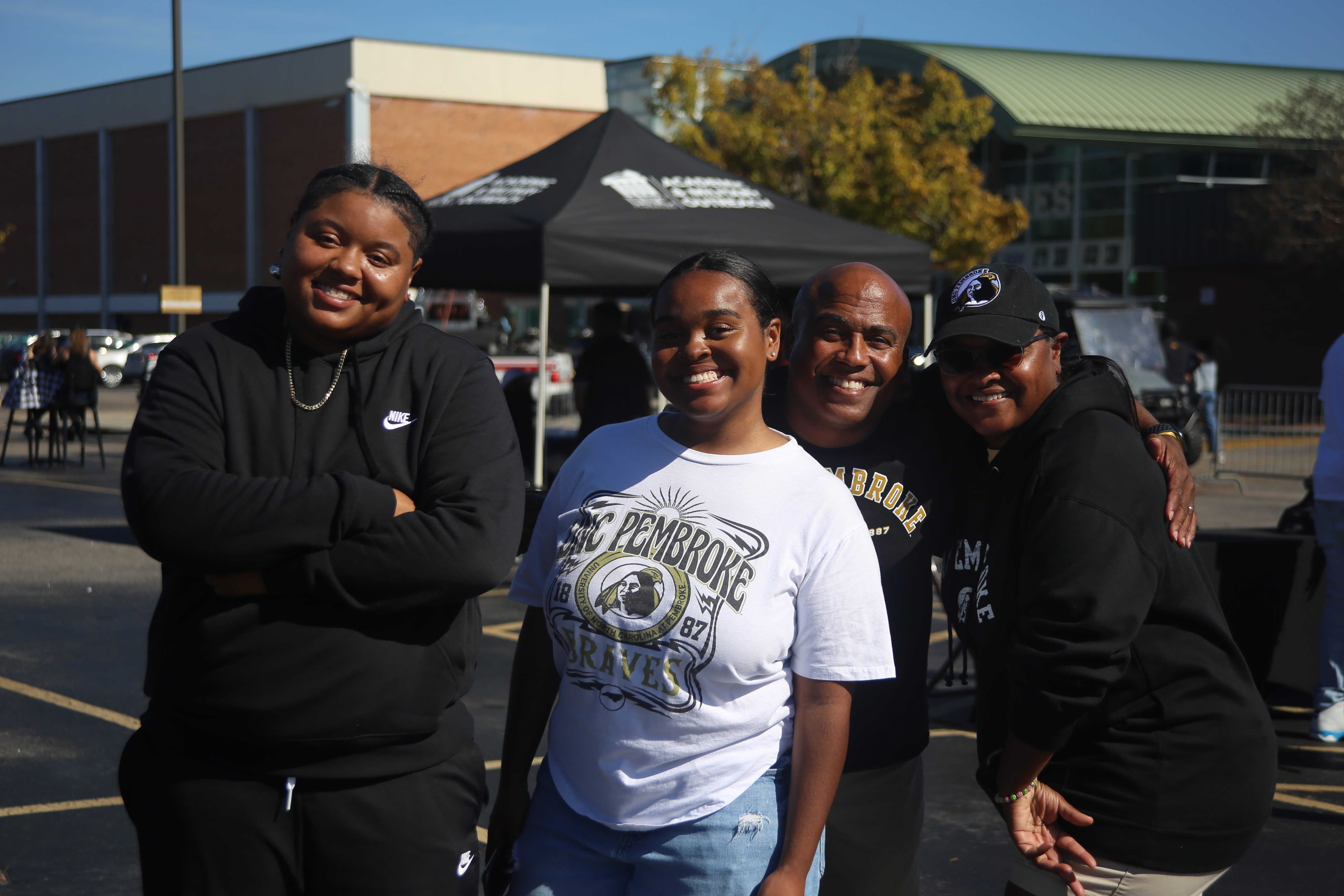 A student with their family at the Family Weekend Tailgate
