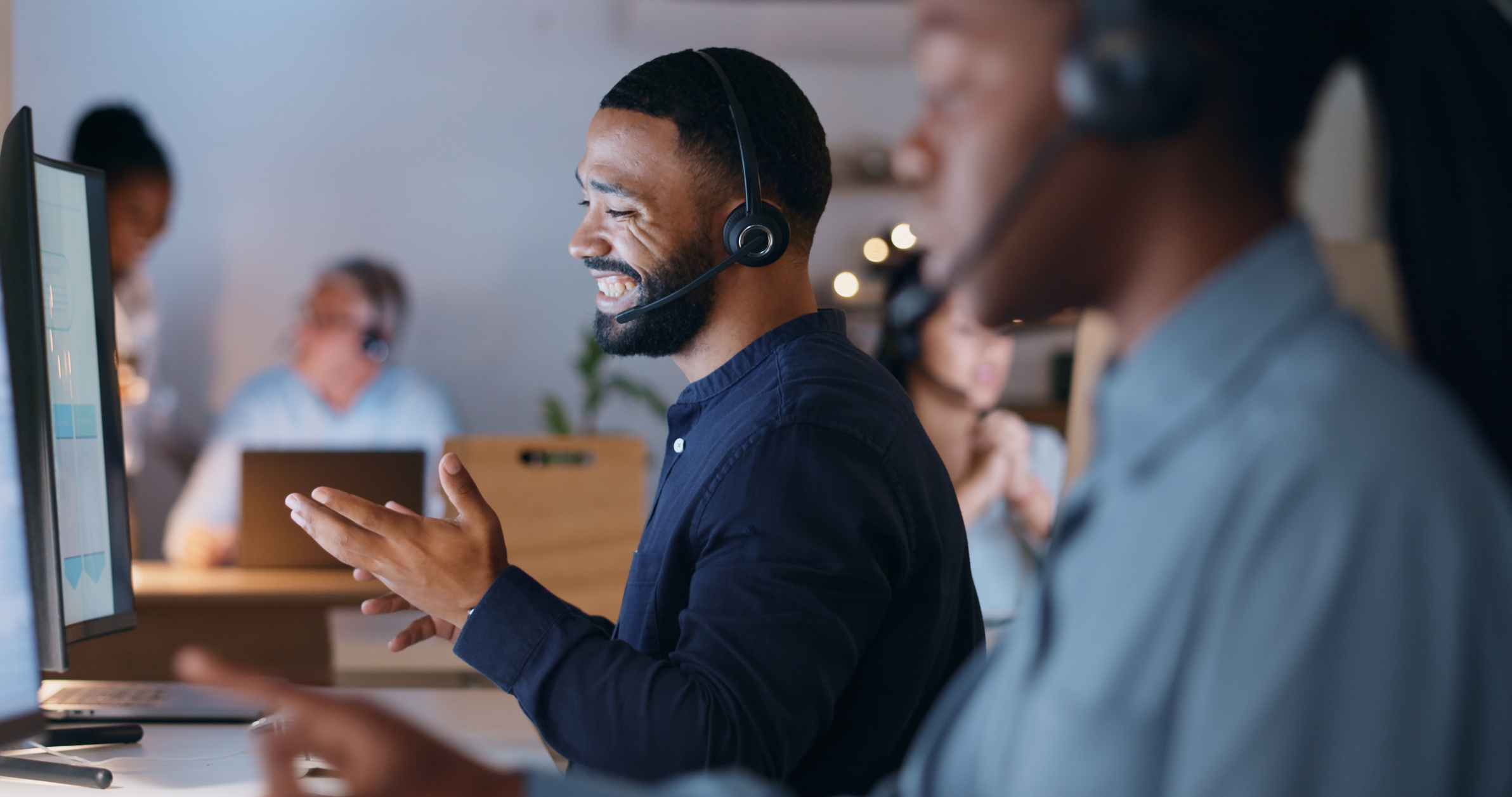 Men talking on headsets at computers