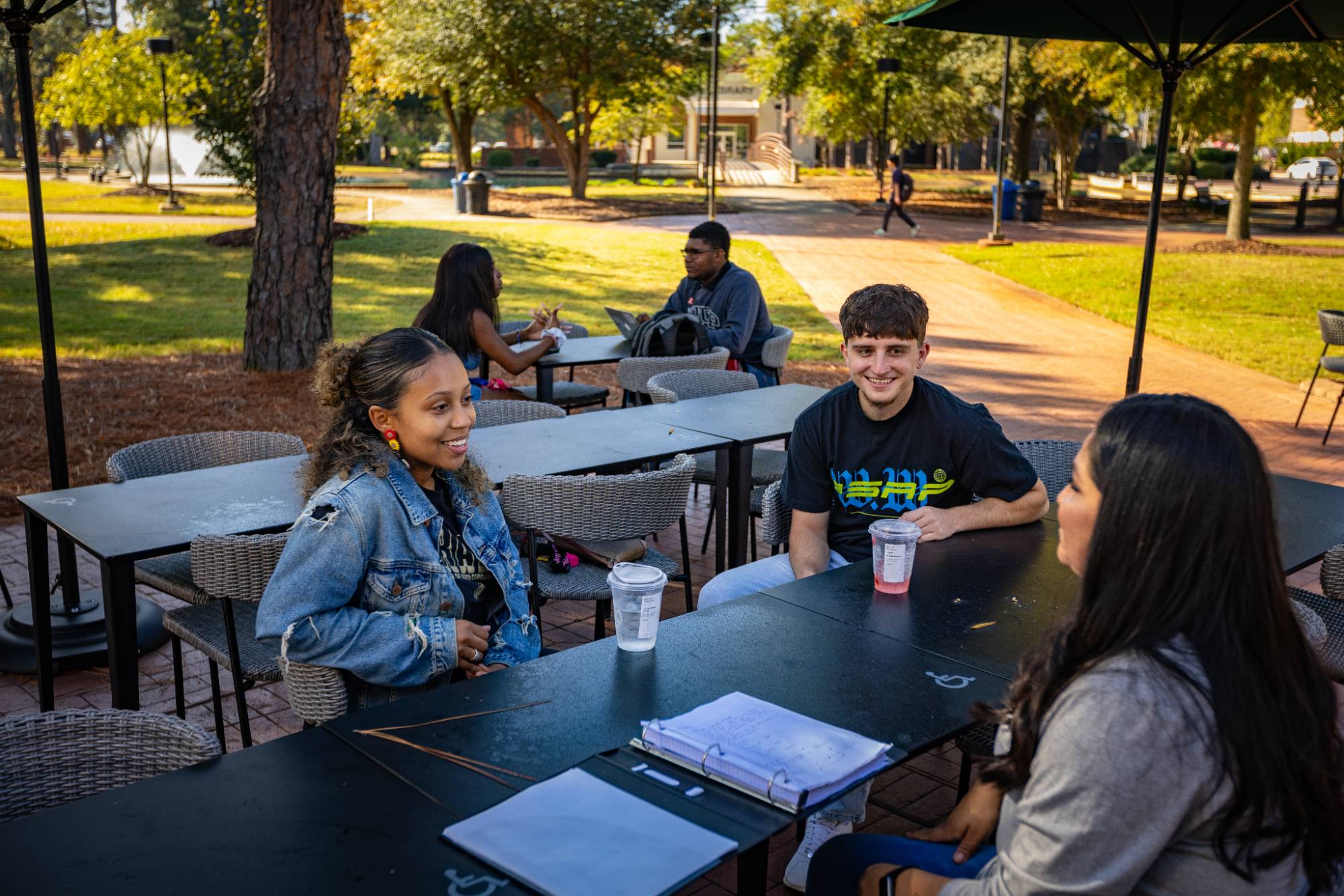 Students studying and drinking coffee on campus