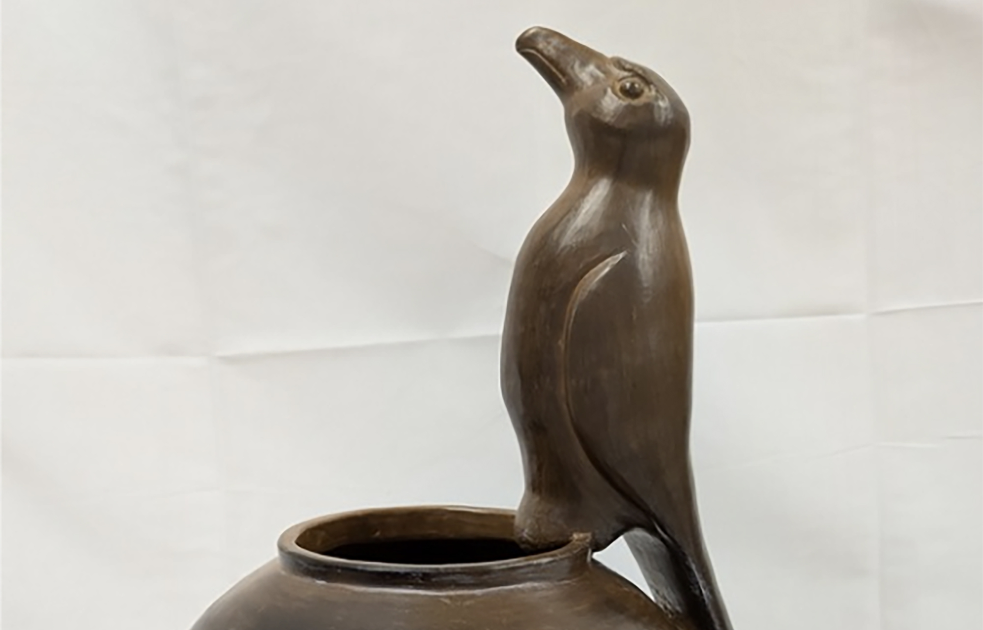 Wooden art project of a bird perched on a vase
