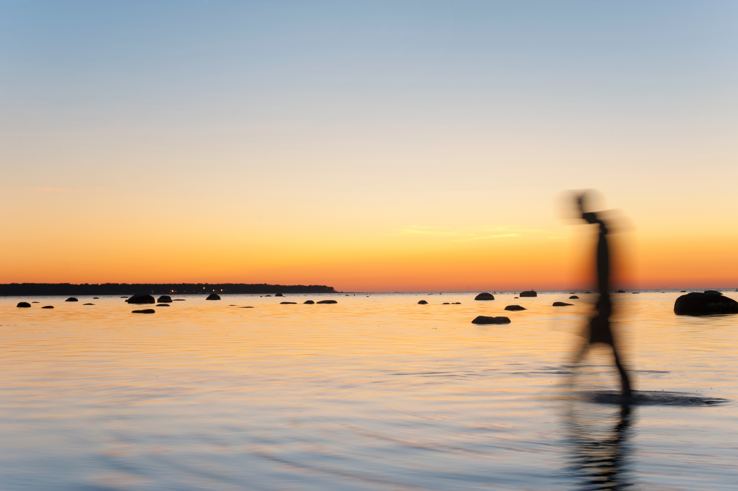 person walking on water with sunset