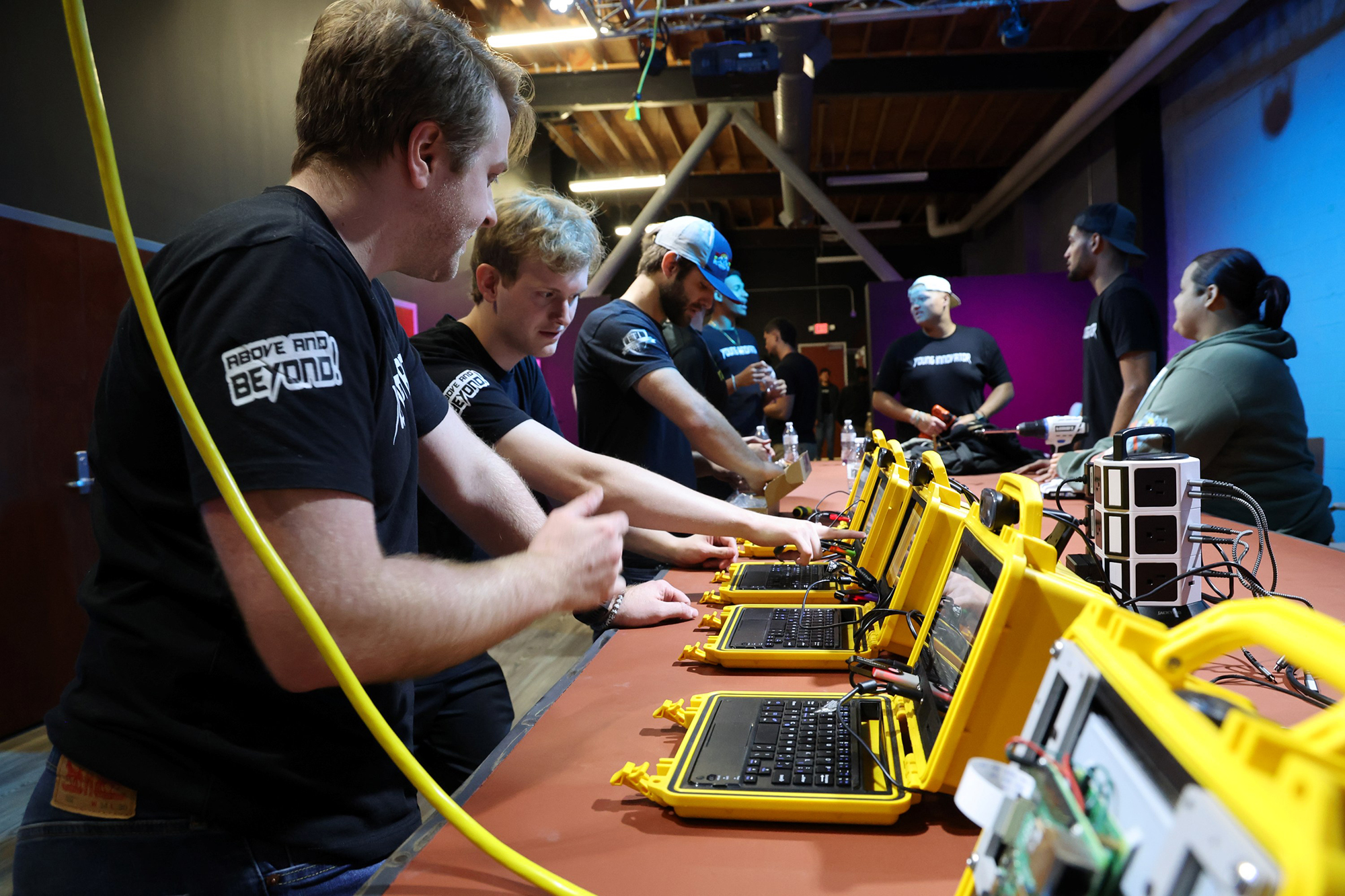 UNCP Computer Science students examine each other's work on ruggedized laptops at a technology innovation showcase.