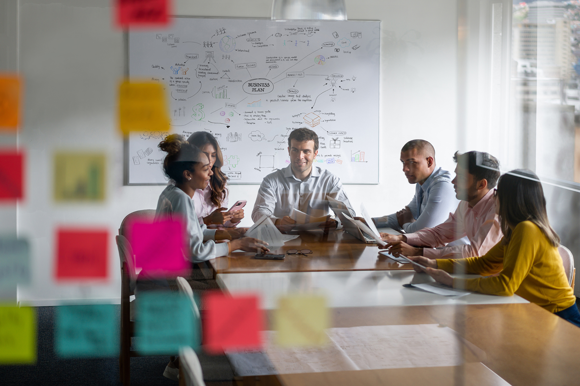 Group of faculty sitting at a table writing